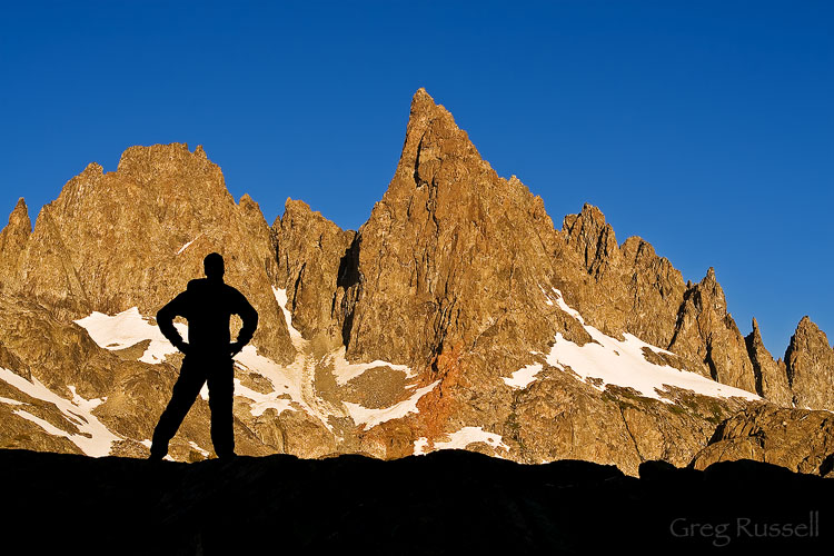 a hiker is silhouetted in front of the minarets, ansel adams wilderness