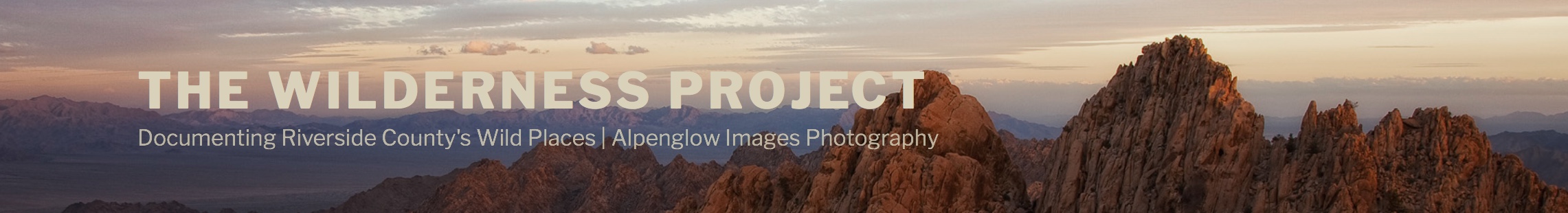 panoramic image with text and colorful mountains at sunset 