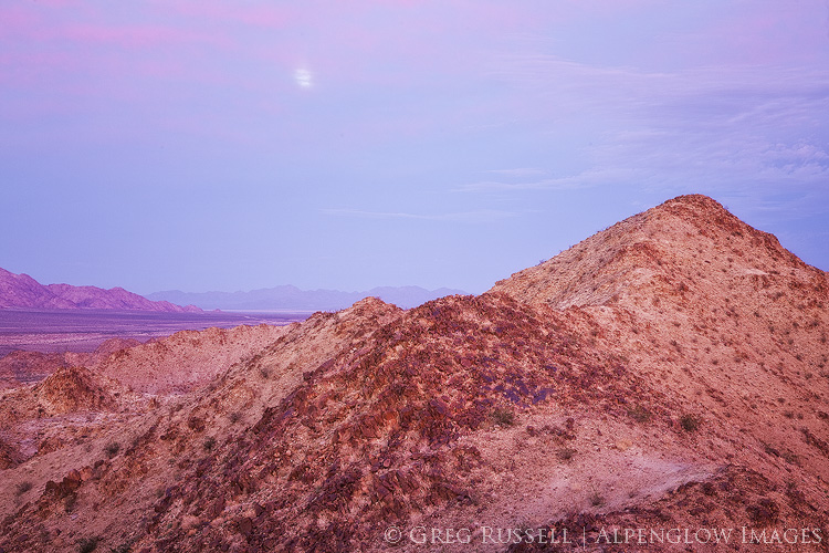 photo of a rising moon at sunset in the orocopia mountains of southern california