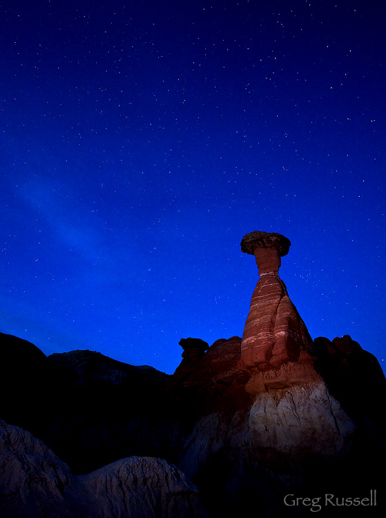 Star light illuminates a hoodoo in the badlands of the southern part of the Grand Staircase-Escalante National Monument, Utah