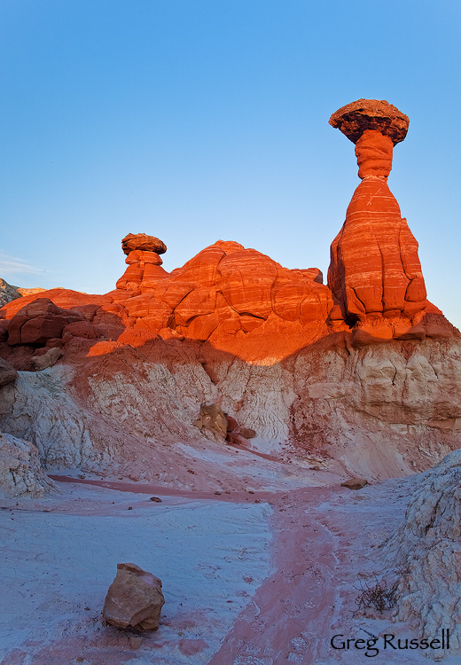 Colorful sunset light illuminates a hoodoo in the badlands of the southern part of the Grand Staircase-Escalante National Monument, Utah