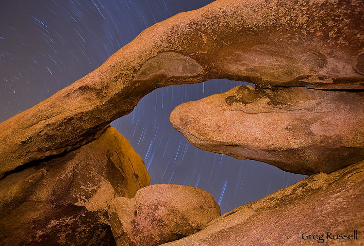 Star trails over Arch Rock, Joshua Tree National Park, California