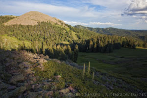 photograph of fading light on a volcanic ridge top and last light on a mountain peak in utah's tushar mountains