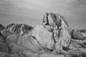 black and white photo of jumbo rocks at sunset in joshua tree national park, california