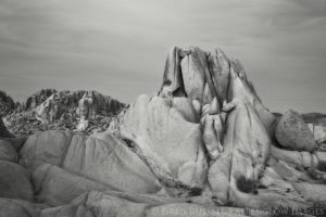 black and white photo of jumbo rocks at sunset in joshua tree national park, california
