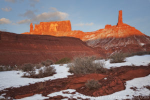 sunset light on the large rock formation called castle ton tower outside of castle valley Utah