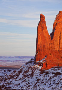 warm sunset light on a rock spire in monument valley tribal park Utah