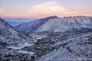 High Sierra Nevada peaks and lakes at sunset.