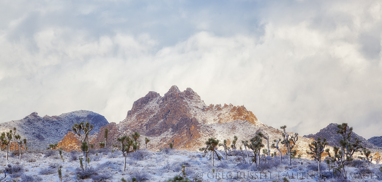 A desert peak is illuminated in sunlight as a winter storm clears from the Mojave Desert